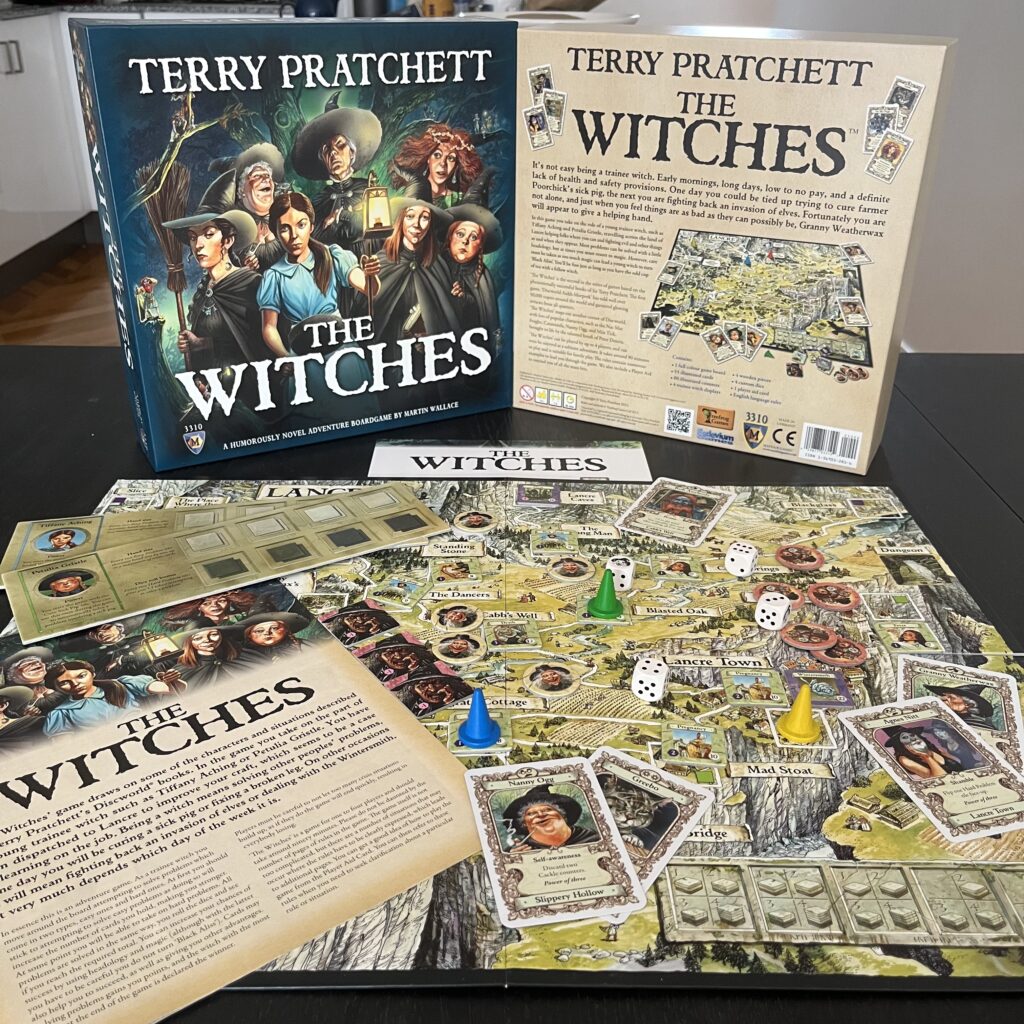 A photo of the board, components, rules and box of The Witches board game.