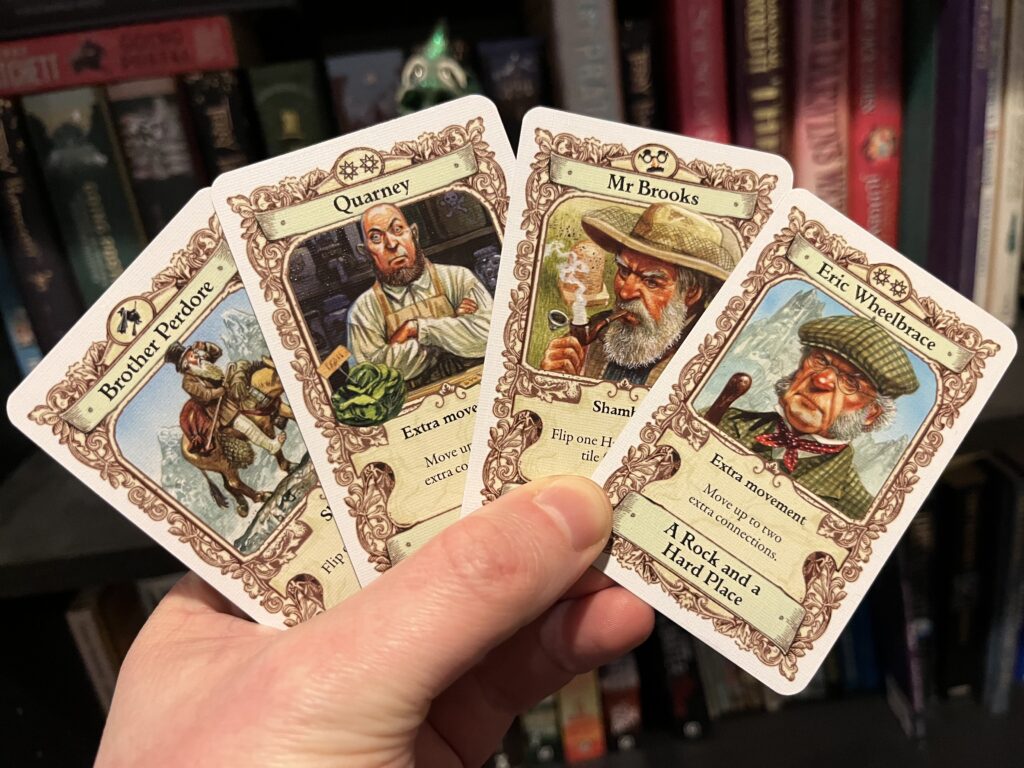 A photo of four cards depicting more obscure characters.