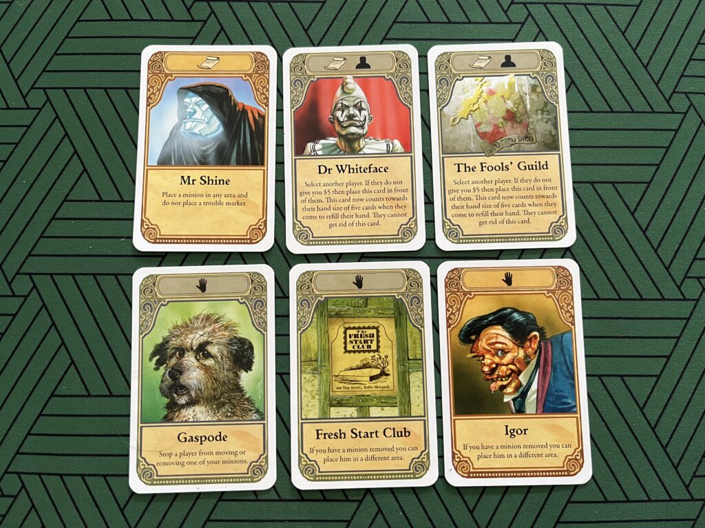 Photo of six player cards from the board game Discworld: Ankh-Morpork.
