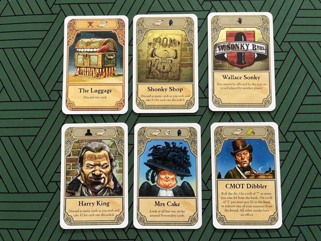 Photo of six player cards from the board game Discworld: Ankh-Morpork.