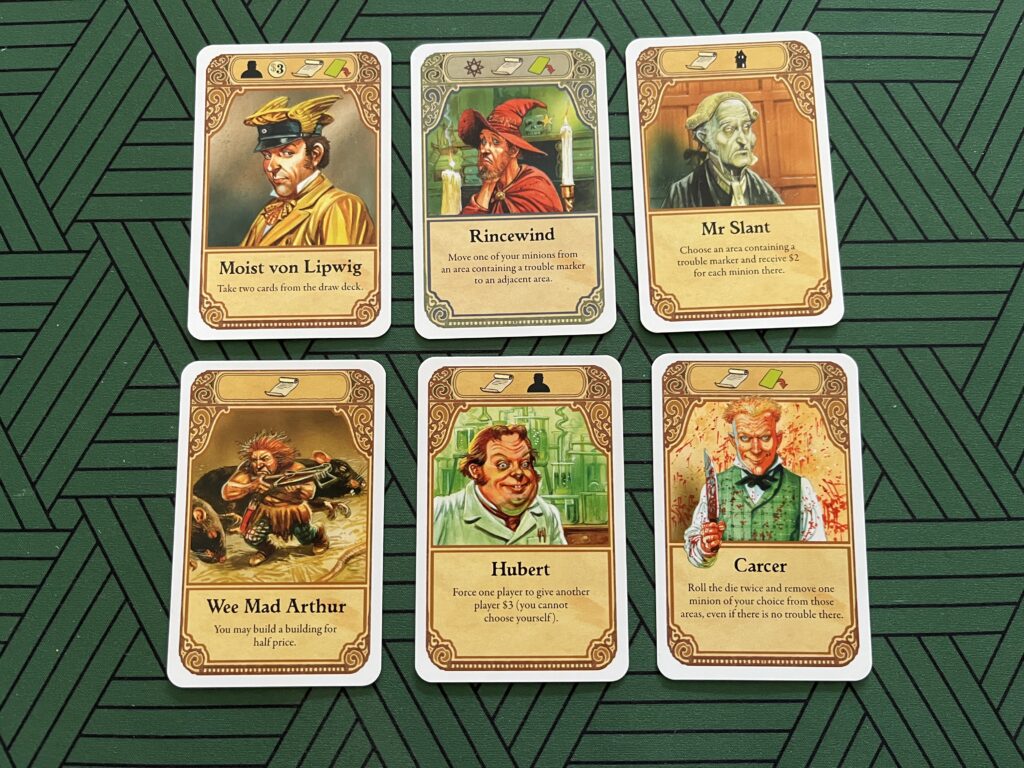 Photo of six player cards from the board game Discworld: Ankh-Morpork.