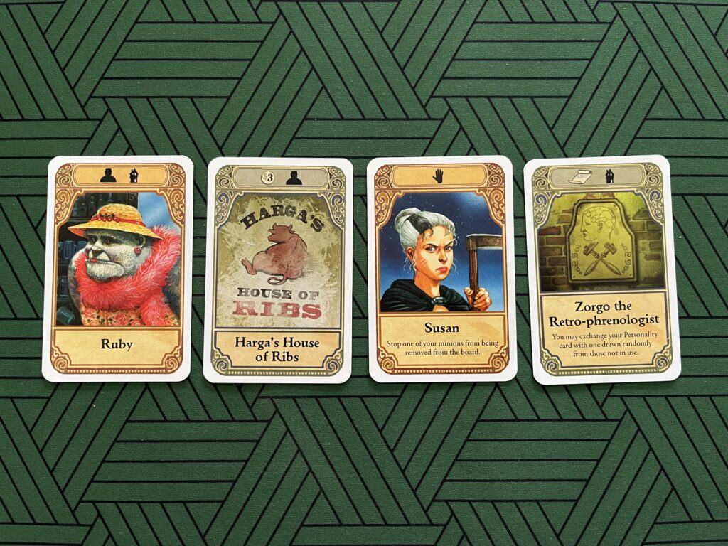 Photo of four player cards from the board game Discworld: Ankh-Morpork.