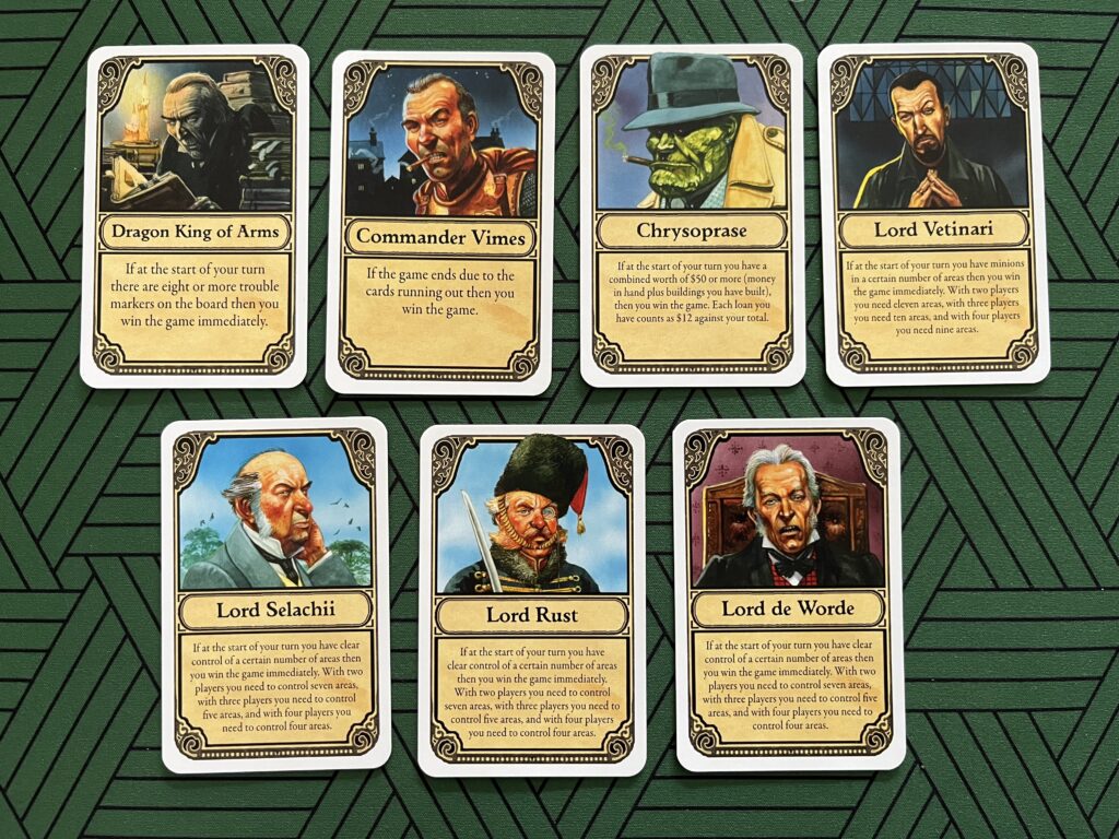 Photo of the seven personality cards from the Discworld: Ankh-Morpork board game: Dragon King of Arms; Commander Vimes; Chrysoprase; Lord Vetinari; Lord Selachii; Lord Rust; Lord de Worde